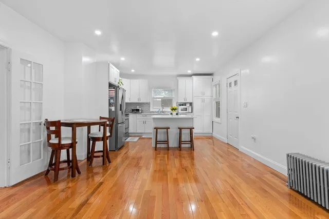 a view of kitchen with furniture and wooden floor