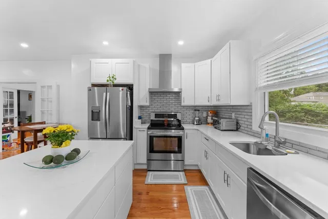 a kitchen with a sink stove and refrigerator