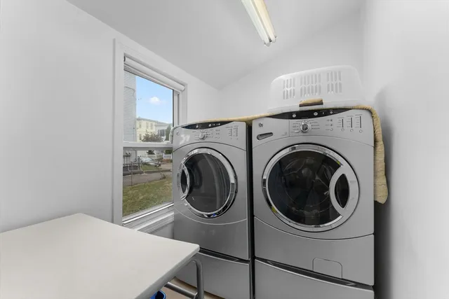 a view of a bedroom with washer and dryer
