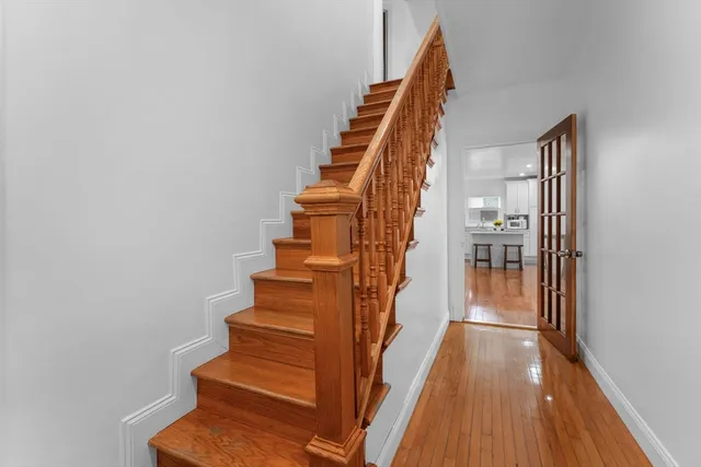 a view of entryway and gallery with wooden floor