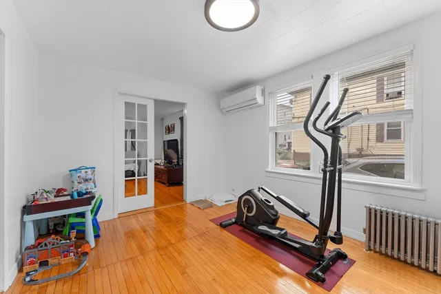 a bedroom with furniture and a wooden floor
