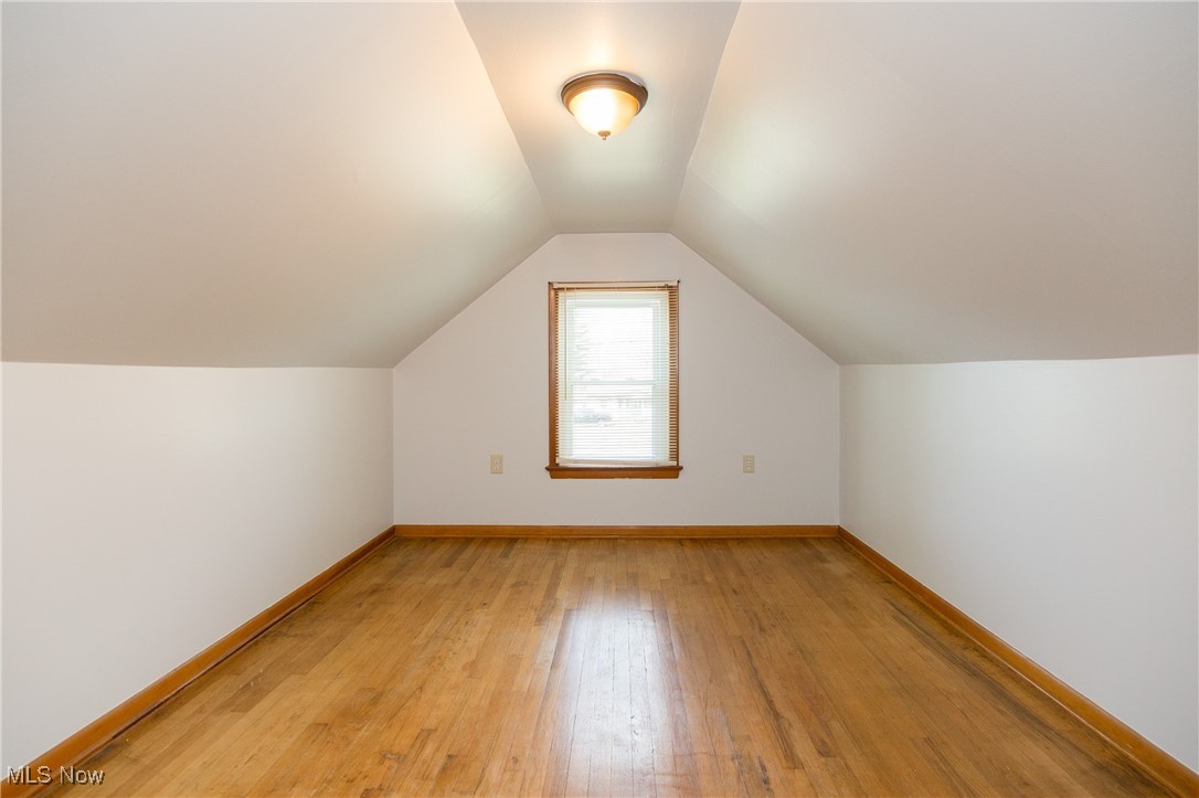 32575 Bagley Road North Ridgeville, OH 44039 - Photo 22 of 30 Additional living space featuring baseboards, light wood finished floors, and vaulted ceiling