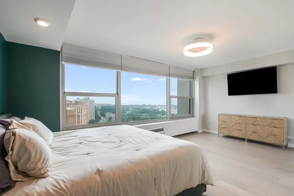 a bedroom with a bed and a television in it