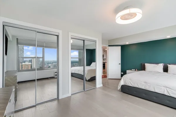 a bedroom with a bed and a large window