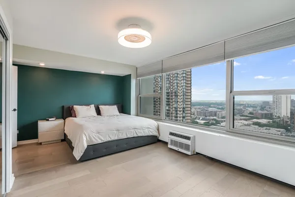 a bedroom with a bed and large window