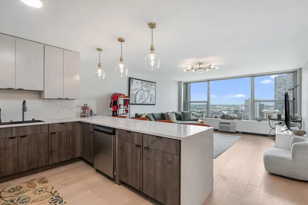 a kitchen with a sink stove and cabinets