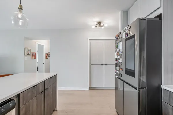 a kitchen with a refrigerator and a sink