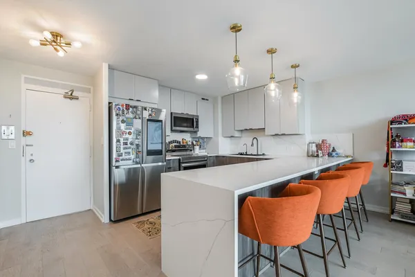 a kitchen with stainless steel appliances kitchen island granite countertop a sink and cabinets
