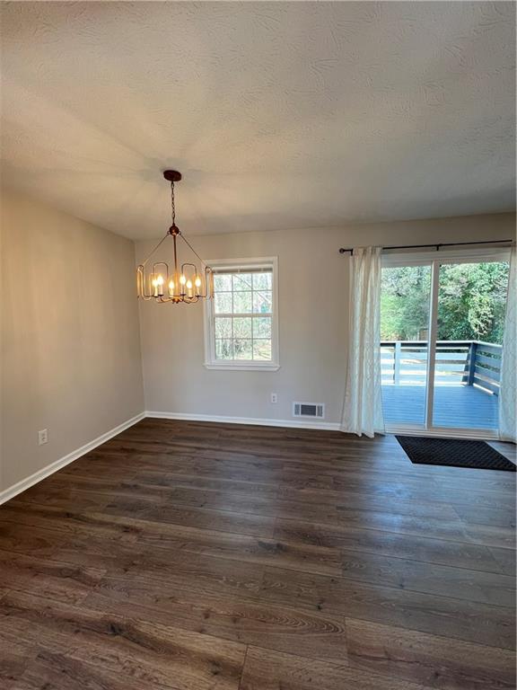 5990 Wellborn Trace Lithonia, GA 30058 - Photo 14 of 56 a view of an empty room with wooden floor and a window