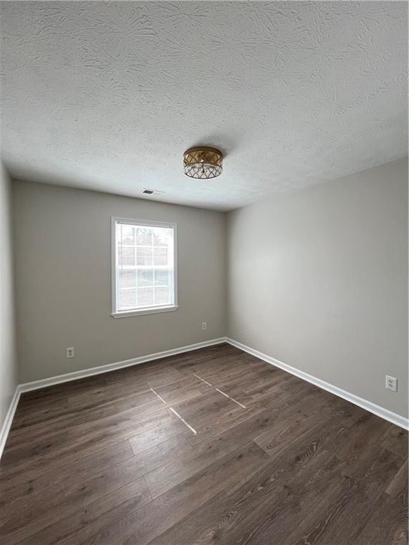 5990 Wellborn Trace Lithonia, GA 30058 - Photo 17 of 56 an empty room with wooden floor and windows