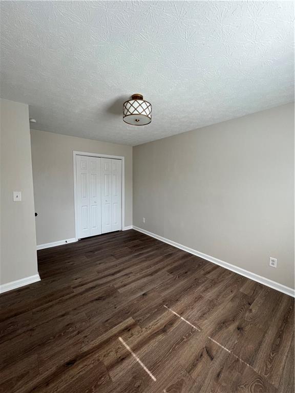 5990 Wellborn Trace Lithonia, GA 30058 - Photo 20 of 56 a view of an empty room with wooden floor and a window