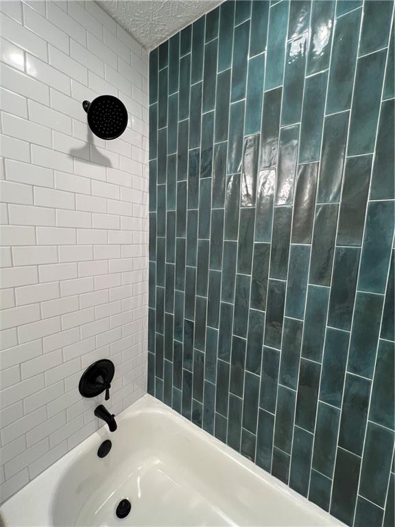 5990 Wellborn Trace Lithonia, GA 30058 - Photo 25 of 56 a bathroom with a sink and a shower