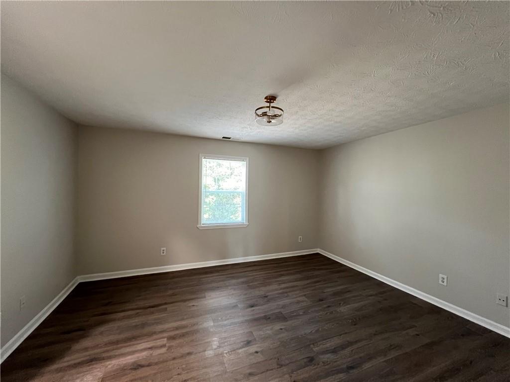 5990 Wellborn Trace Lithonia, GA 30058 - Photo 28 of 56 a view of an empty room with wooden floor and a window