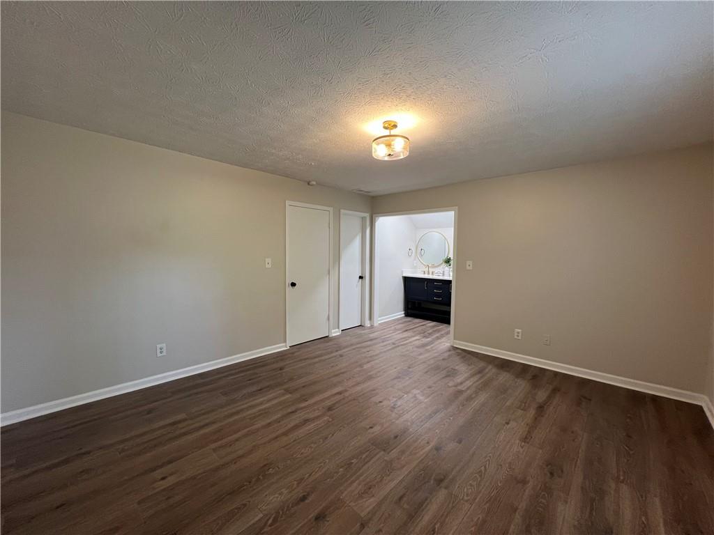 5990 Wellborn Trace Lithonia, GA 30058 - Photo 29 of 56 a view of an empty room with wooden floor and a window