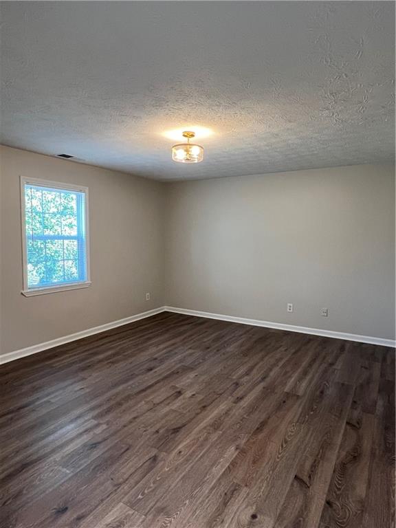 5990 Wellborn Trace Lithonia, GA 30058 - Photo 30 of 56 an empty room with wooden floor and windows