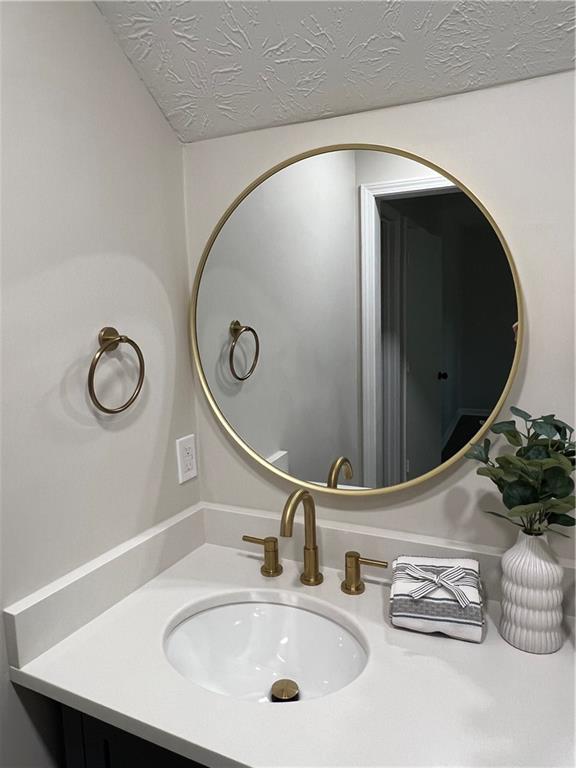 5990 Wellborn Trace Lithonia, GA 30058 - Photo 33 of 56 a bathroom with a sink and a mirror
