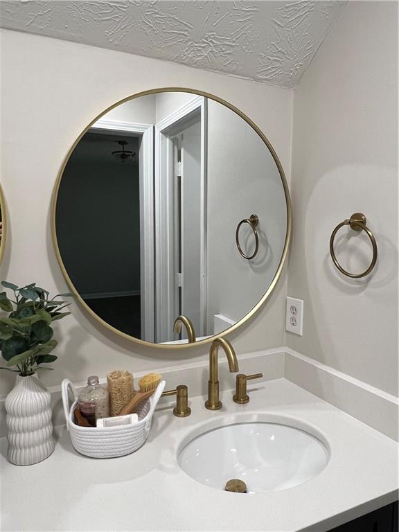 5990 Wellborn Trace Lithonia, GA 30058 - Photo 34 of 56 a bathroom with a sink and a mirror