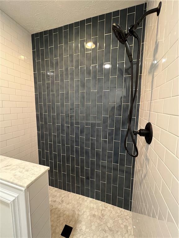 5990 Wellborn Trace Lithonia, GA 30058 - Photo 37 of 56 a bathroom with a shower and a sink