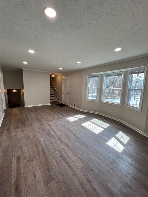 5990 Wellborn Trace Lithonia, GA 30058 - Photo 4 of 56 an empty room with wooden floor and windows