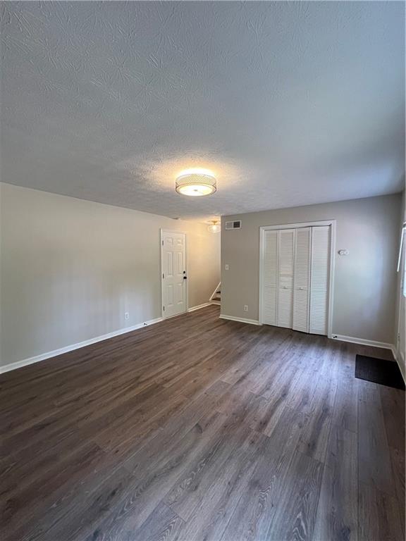 5990 Wellborn Trace Lithonia, GA 30058 - Photo 42 of 56 a view of an empty room with wooden floor