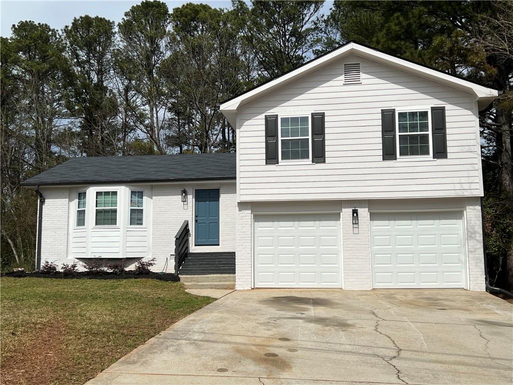 5990 Wellborn Trace Lithonia, GA 30058 - Photo 55 of 56 a front view of a house with a yard
