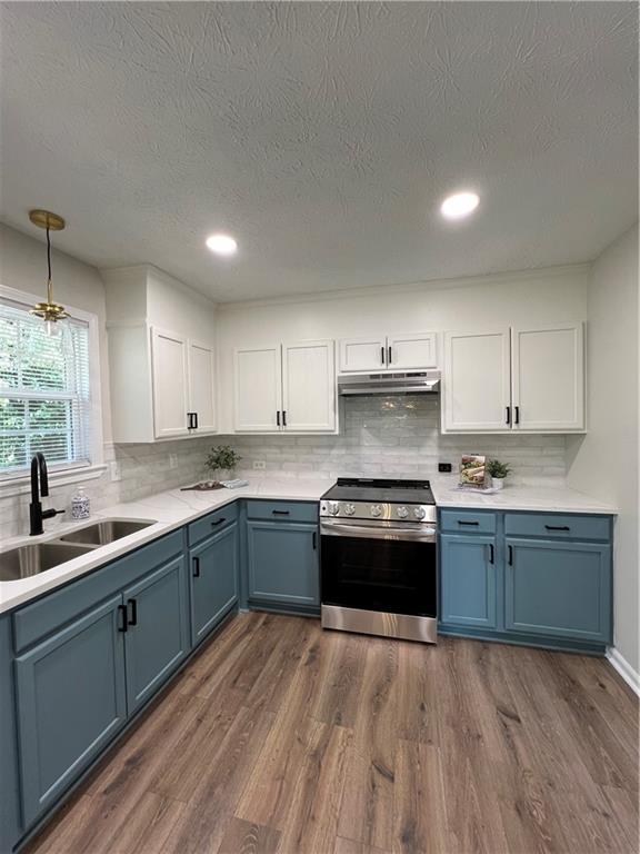 5990 Wellborn Trace Lithonia, GA 30058 - Photo 7 of 56 a kitchen with stainless steel appliances granite countertop a stove a sink and a refrigerator