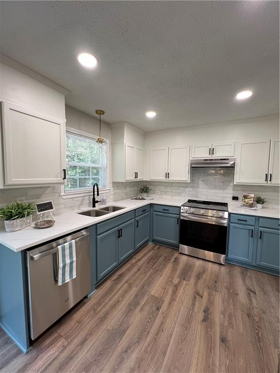 5990 Wellborn Trace Lithonia, GA 30058 - Photo 8 of 56 a large kitchen with stainless steel appliances granite countertop a stove a sink dishwasher and a refrigerator