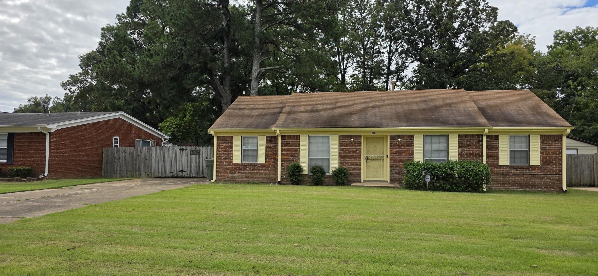 View of front of house featuring brick siding and concrete driveway