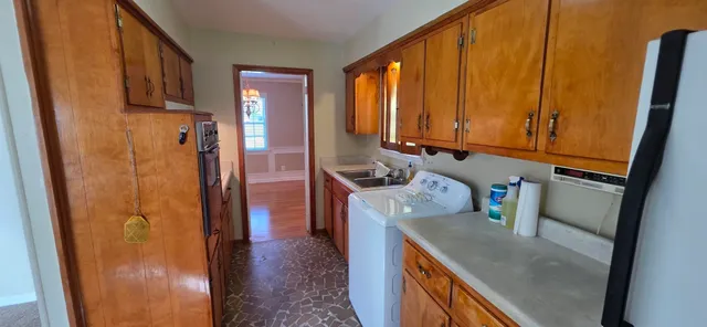 a kitchen with sink refrigerator and microwave