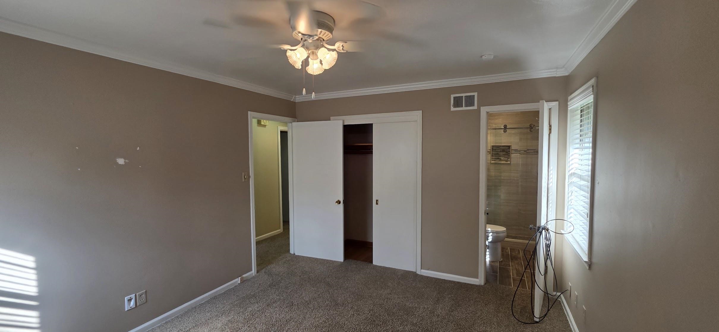 523 Shofner Avenue Memphis, TN 38109 - Photo 10 of 12 Unfurnished bedroom with ornamental molding, dark carpet, a closet, ceiling fan, and ensuite bath