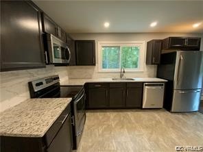 11900 Deerhurst Drive Midlothian, VA 23113 - Photo 18 of 33 a kitchen with stainless steel appliances granite countertop a sink stove microwave and refrigerator