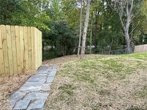 11900 Deerhurst Drive Midlothian, VA 23113 - Photo 7 of 33 a backyard of a house with large trees