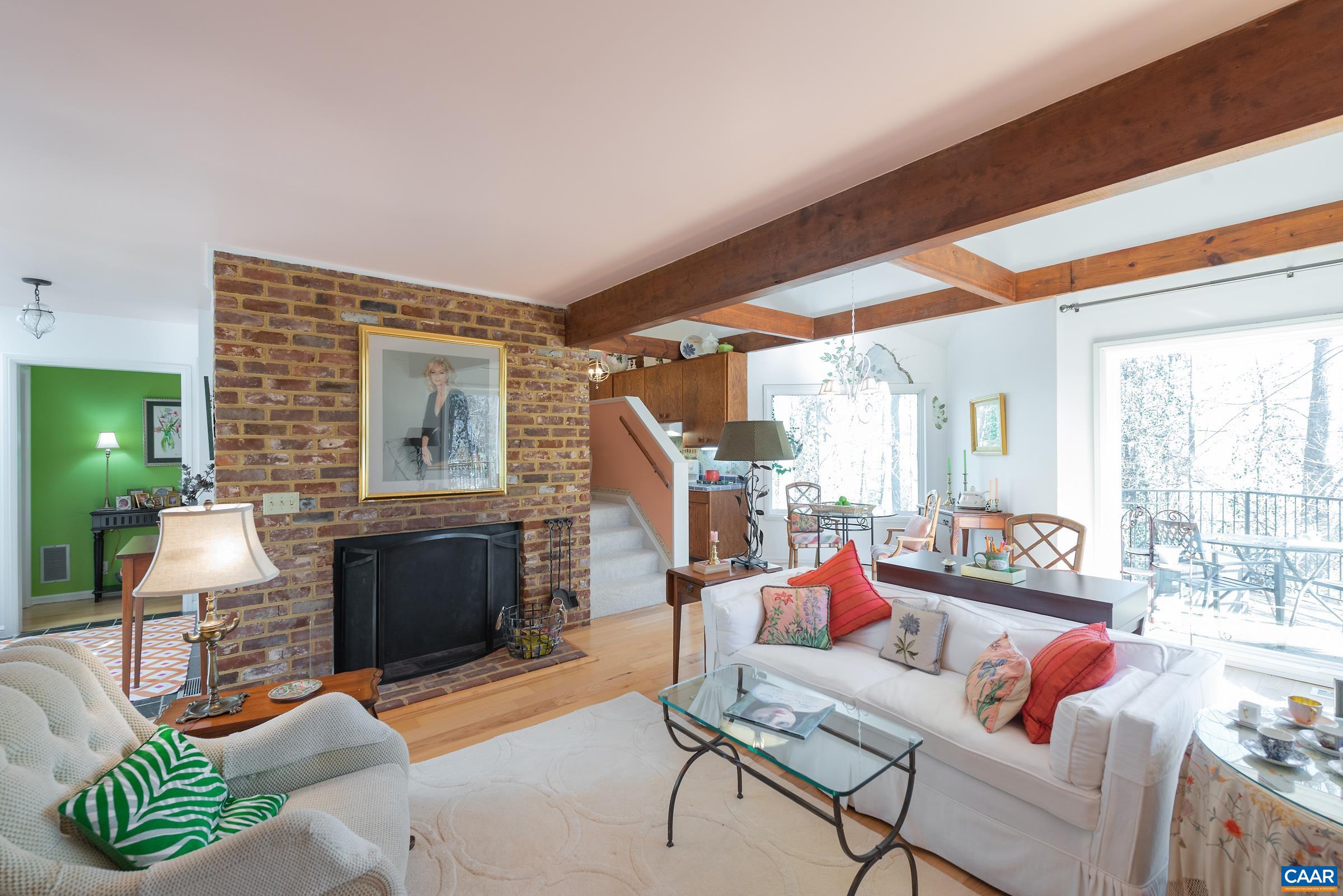 659 Broomley Road Charlottesville, VA 22901 - Photo 19 of 32 a living room with furniture a fireplace and a large window