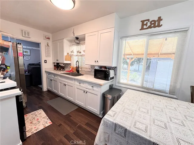 a kitchen with a stove a sink and a refrigerator