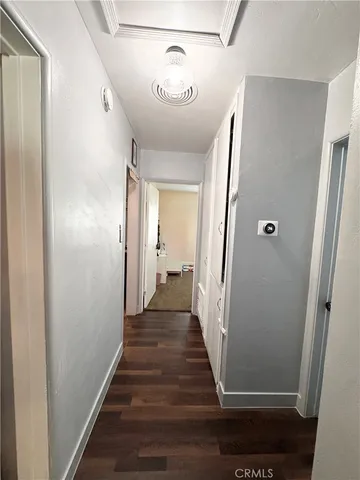 a view of a hallway with wooden floor