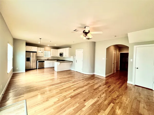 a view of a kitchen with kitchen island a sink stainless steel appliances and cabinets