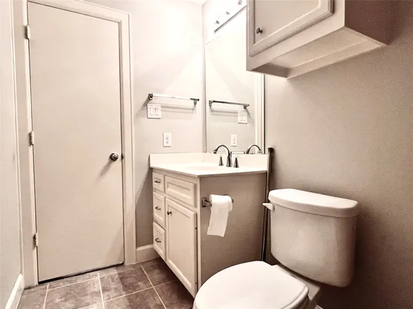 a white toilet sitting next to a bathroom sink