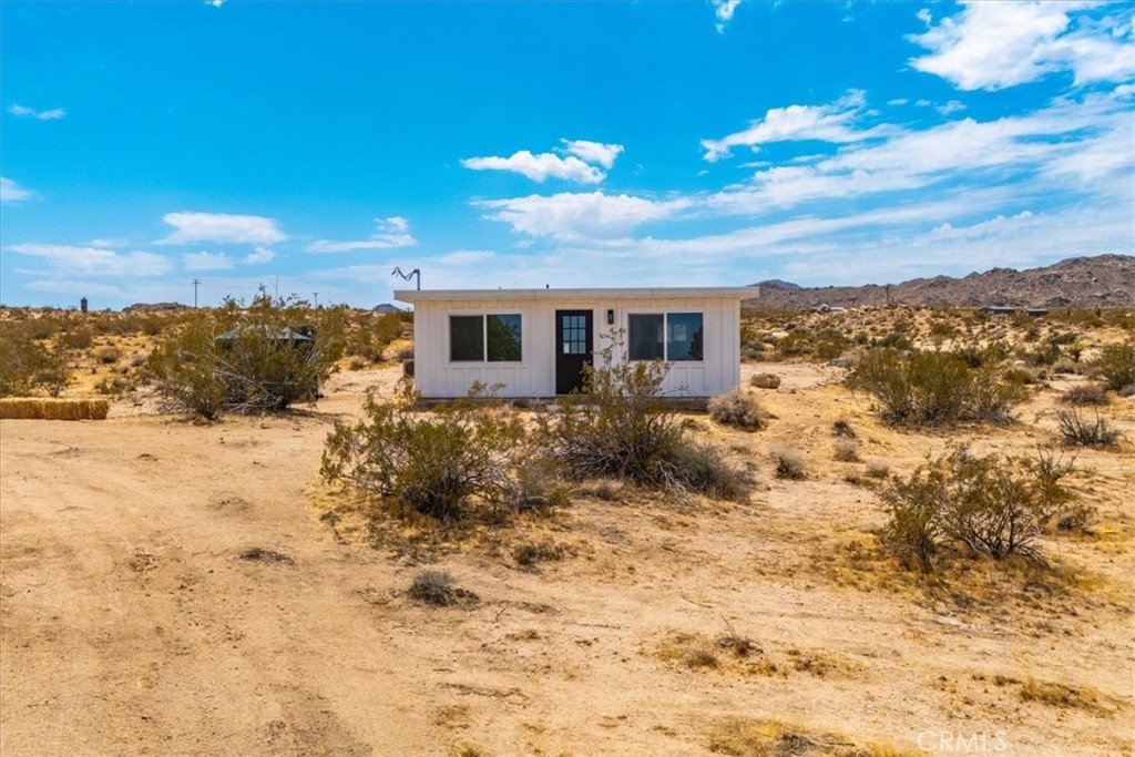 777 Quail Bush Road Landers, CA 92285 - Photo 20 of 46 a view of a house with a yard