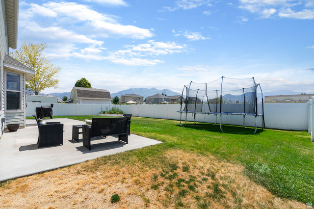 1393 West 150 North Springville, UT 84663 - Photo 22 of 31 Expansive backyard featuring a concrete patio, a vast lawn area, and a white privacy fence
