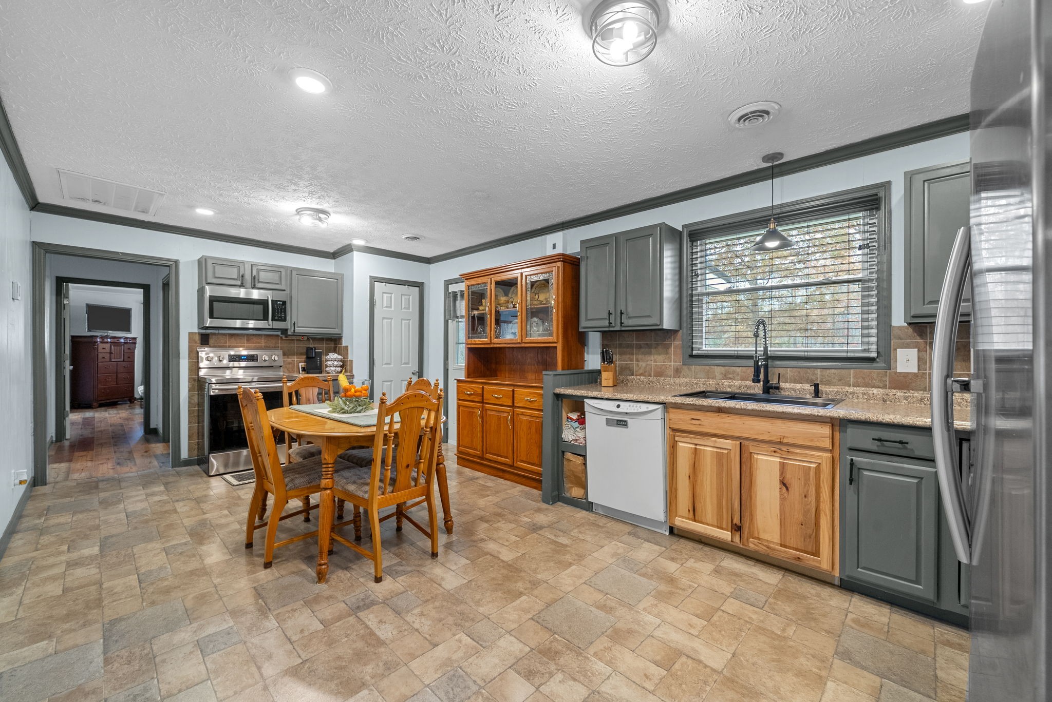2126 Foster Road Cumberland Furnace, TN 37051 - Photo 14 of 42 a kitchen with stainless steel appliances granite countertop a table chairs sink and window