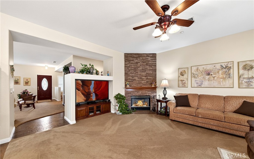 7619 Vista Rio Road Highland, CA 92346 - Photo 11 of 25 a living room with furniture and a fireplace