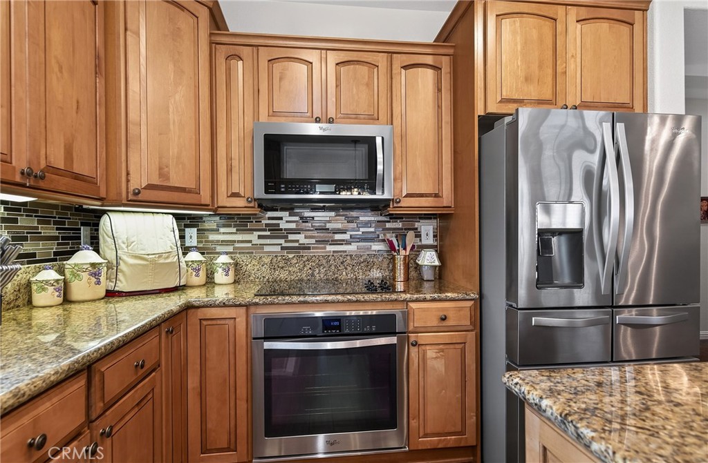 7619 Vista Rio Road Highland, CA 92346 - Photo 13 of 25 a kitchen with stainless steel appliances granite countertop a refrigerator stove and sink