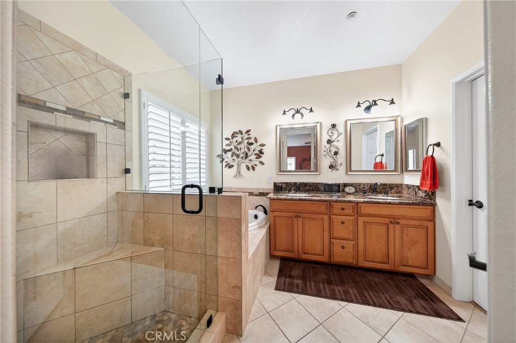 7619 Vista Rio Road Highland, CA 92346 - Photo 16 of 25 a bathroom with granite countertop shower sink and mirror