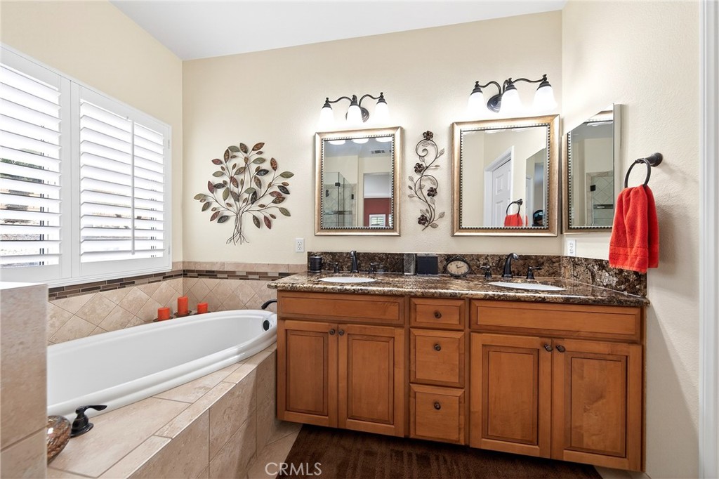 7619 Vista Rio Road Highland, CA 92346 - Photo 17 of 25 a bathroom with a tub sink and mirror