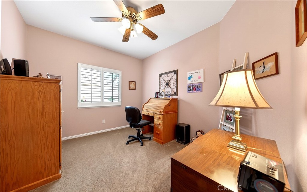 7619 Vista Rio Road Highland, CA 92346 - Photo 18 of 25 a view of a workspace with furniture and a window