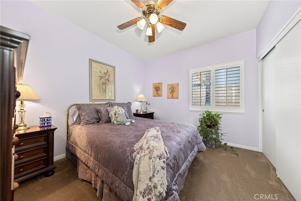 7619 Vista Rio Road Highland, CA 92346 - Photo 20 of 25 a bedroom with a bed and a chandelier