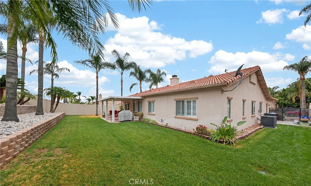 7619 Vista Rio Road Highland, CA 92346 - Photo 23 of 25 a view of a house with a yard and potted plants
