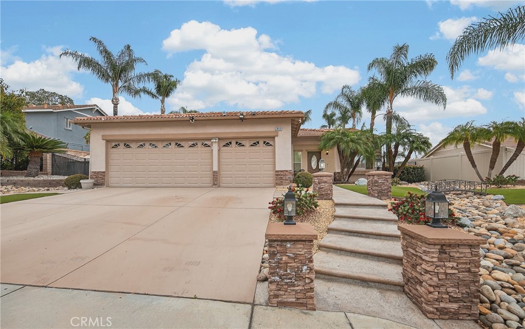 7619 Vista Rio Road Highland, CA 92346 - Photo 4 of 25 a front view of a house with a garden
