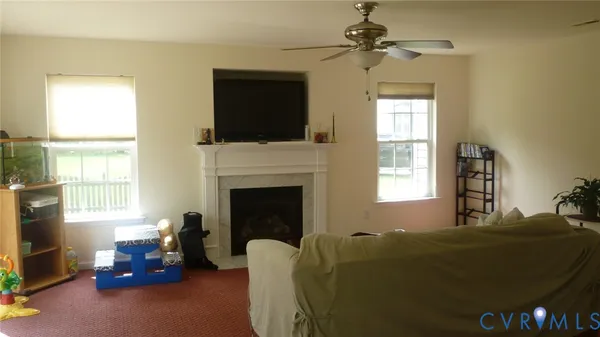 a living room with furniture window and flat screen tv