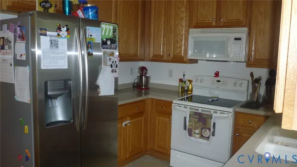 a kitchen with stainless steel appliances granite countertop a refrigerator and a stove